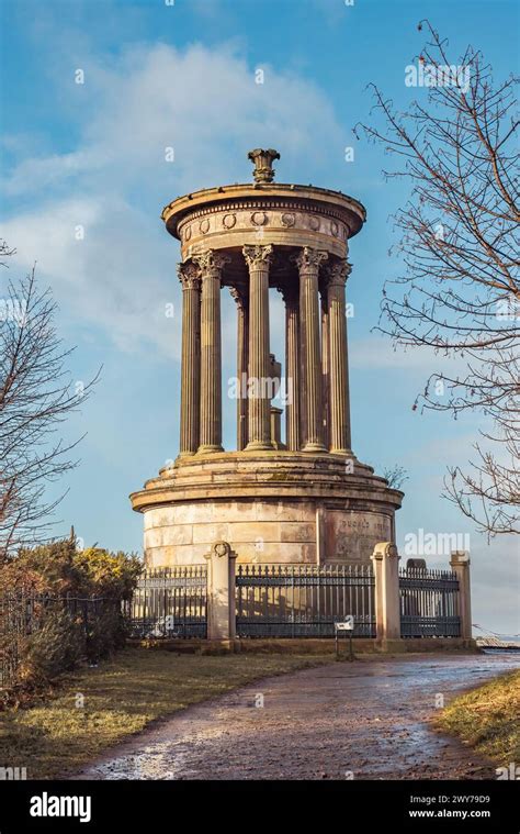 The Dugald Stewart Monument At Calton Hill In Edinburgh Against A Blue