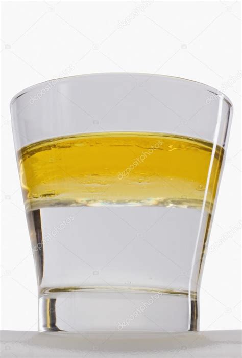 Oil floating on water surface in a glass — Stock Photo © imagedb_seller #33026169