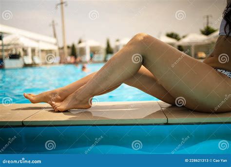 Elegant Woman In White Bikini In The Sun Tanned Slim And Slender Body