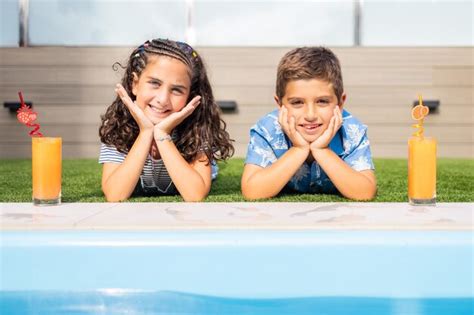 Premium Photo | Two cute kids drinking orange juice outdoors