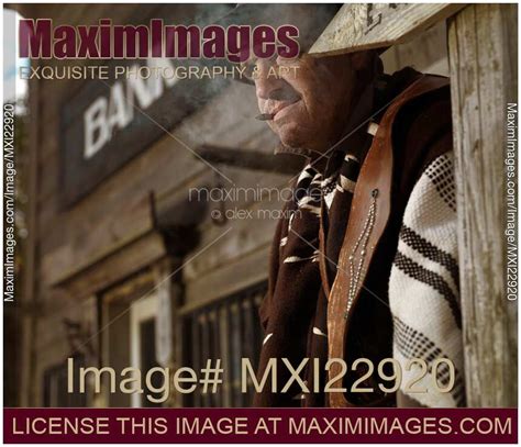 Photo Of Cowboy Smoking A Cigar Outside Of A Bank Building Notorious