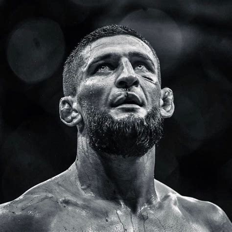 A Black And White Photo Of A Man With A Beard Looking Up At The Sky