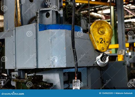 Bridge Lifting Crane Hook Against The Background Of The Assembly Line