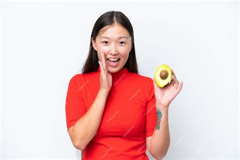 premium photo young asian woman holding  avocado isolated  white