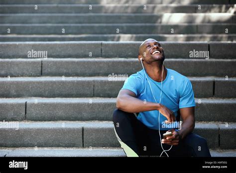 Portrait Of A Happy African American Man Laughing With Mobile Phone And