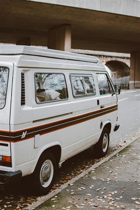 A White Van Parked On The Street Side Near Building · Free Stock Photo