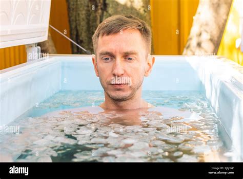 Boy Or Man Bathing In The Cold Water Among Ice Cubes Wim Hof Method