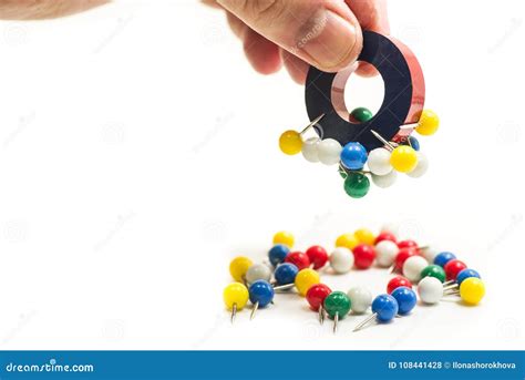 Man Hand Holding A Magnet Attracting Metal Pins Stock Photo Image Of