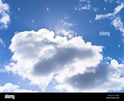 dh White clouds SKY UK Backlit cloud blue sky white grey clouds puffy fluffy cloudscape day ...