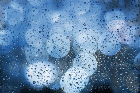 Abstract background with raindrops and soft blue bokeh. Defocused ...