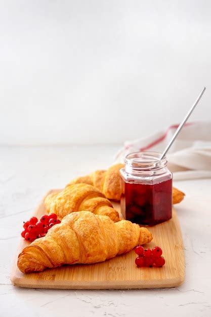 Premium Photo | French healthy breakfast with berry, croissansts and jam