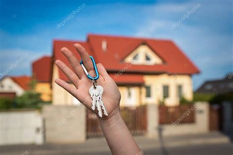 Real Estate Agent Giving House Keys To A New Property Owner Stock Photo