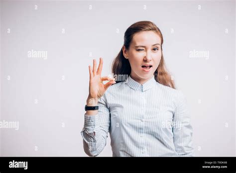 Cute coquettish woman shows gesture OK on a white background Stock ...