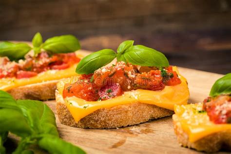 Bruschetta With Salami And Olives On Wood From Above Stock Photo