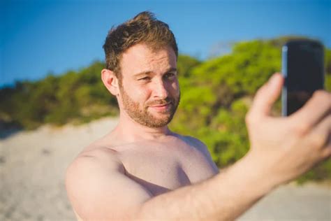 Smiling Shirtless Man Taking Selfie Surfboard Beach Sunny Day Stock