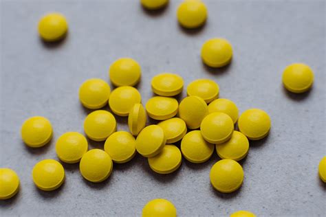 Yellow Medication Pills on Gray Surface · Free Stock Photo