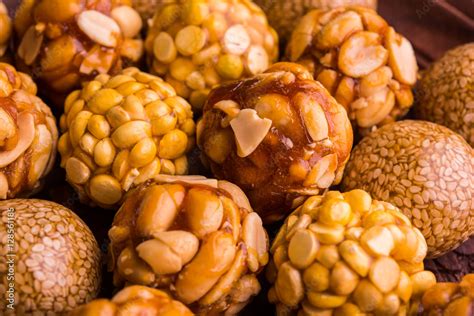 indian sweet til or sesame laddu, groundnut or peanut or mungfali ladoo and chana / daliya ...