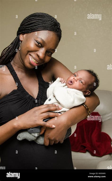 Attractive African American Mother Holding Newborn Baby Boy Stock Photo ...