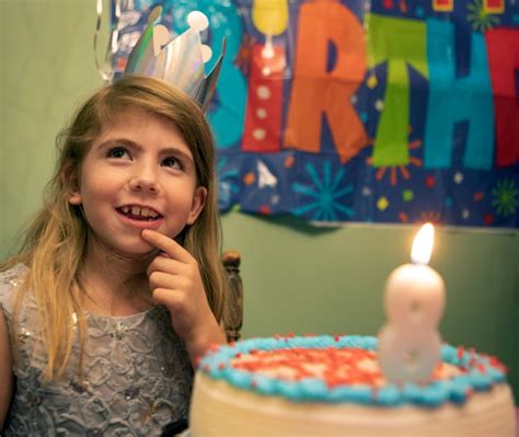 Premium Photo Portrait Of Young Woman Blowing Birthday Candles