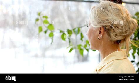 Anonymous Blonde Looking Through Window Stock Photo Alamy