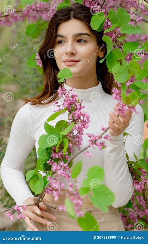 Pretty Brunette Girl Having Photoshoot In Blossom Holding Lilac By Hands Smiling Stock Image