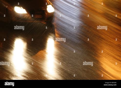 fast car driving in heavy rain at night in town Stock Photo - Alamy