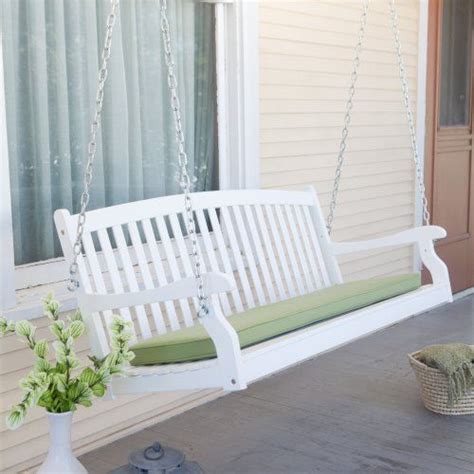 A White Porch Swing With A Free Shipping Sign