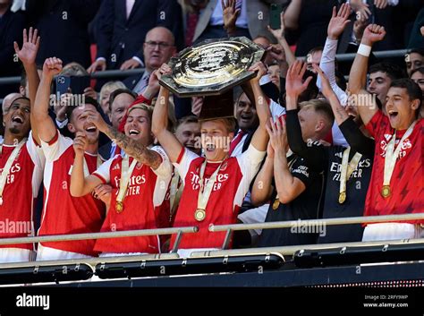 Arsenals Martin Odegaard Centre And Team Mates Lift The Trophy After