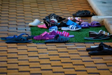 Several Pairs Of Flip Flops Next To Open Pool In Winter Stock Image