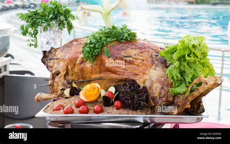 Whole roasted lamb with vegetables and rice Stock Photo - Alamy