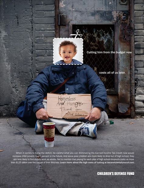 a man sitting on the ground holding a cardboard sign