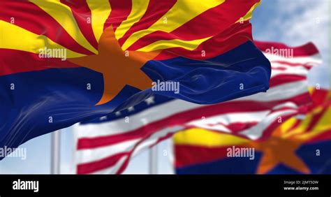 The Flags Of The Arizona State And United States Waving In The Wind