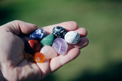 Premium Photo Cropped Hand Of Person Holding Colorful Stones