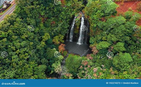 Drone Moves Away From A Mountain Waterfall In The Forest Opaekaa Falls