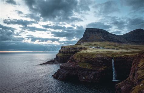 Gasadalur Village And Mulafossur Its Iconic Waterfall During Sunset In