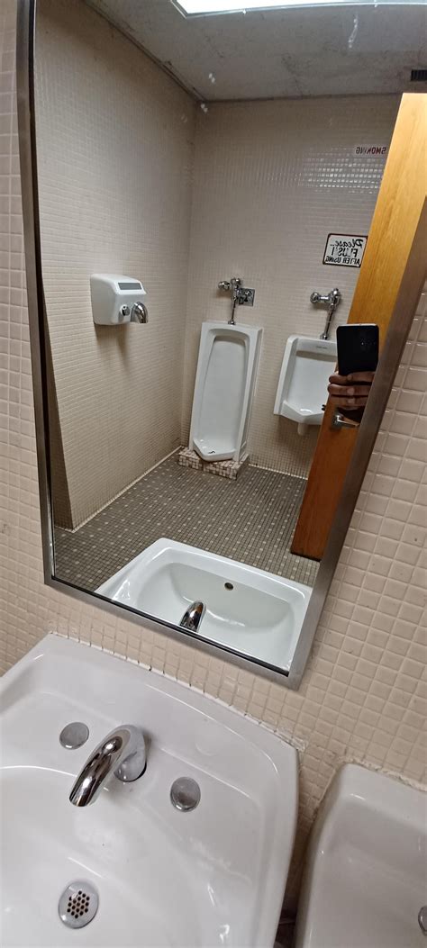 a nicely hidden set of urinals, directly behind the bathroom door when