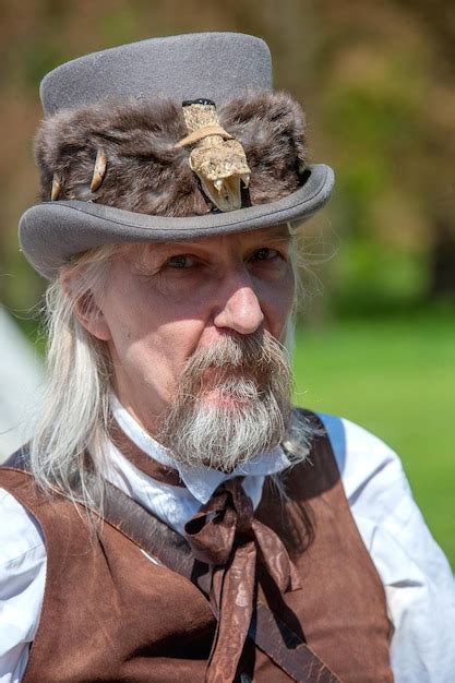 Premium Photo Portrait Of Bearded Mature Man Wearing Hat Outdoors