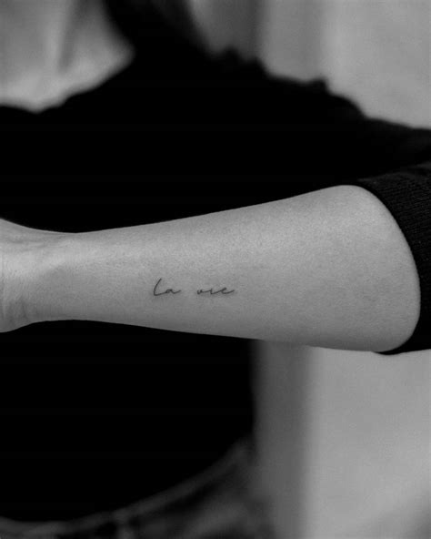 La Vie Lettering Tattoo Handwritten On The Wrist