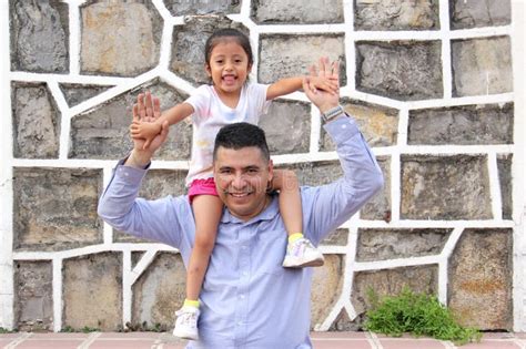 Dad Carries His Year Old Latina Daughter As Piggy Back Spends Quality Time And Celebrates