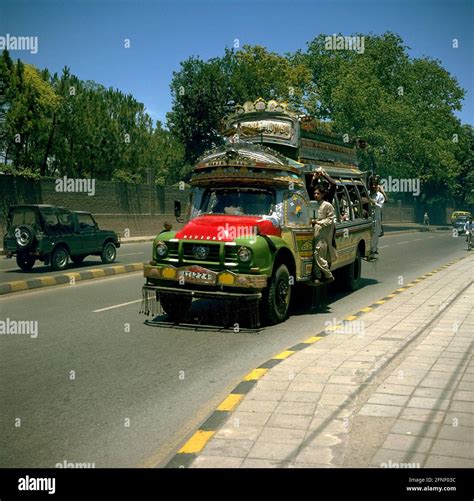 A packed colorful bus on a street in Peshawar. Even on the running ...