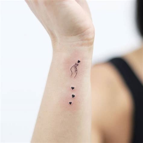 Korean finger heart tattoo located on the wrist,