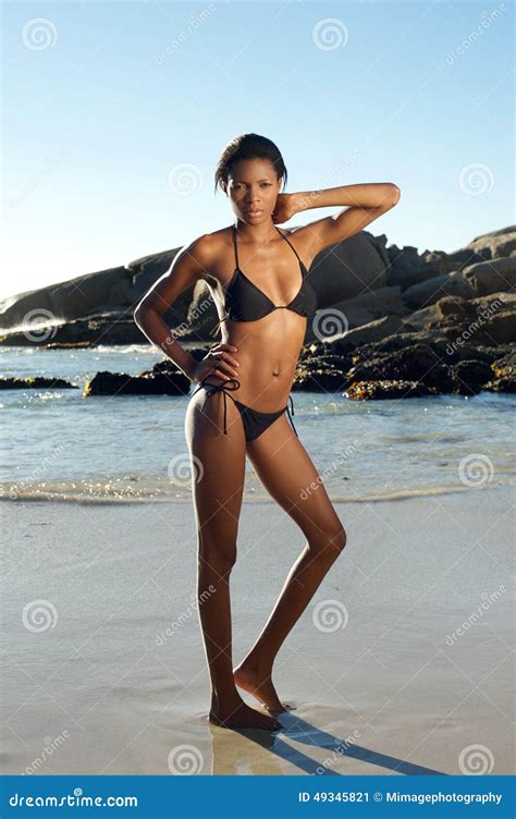 Attractive Female Model In Bikini Standing At The Beach Stock Image