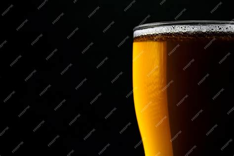 Premium Photo Glass Of Fresh Beer Isolated On A Black Background Closeup