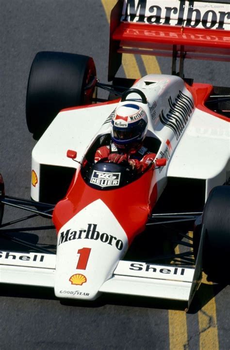 A Man Driving A Red And White Race Car