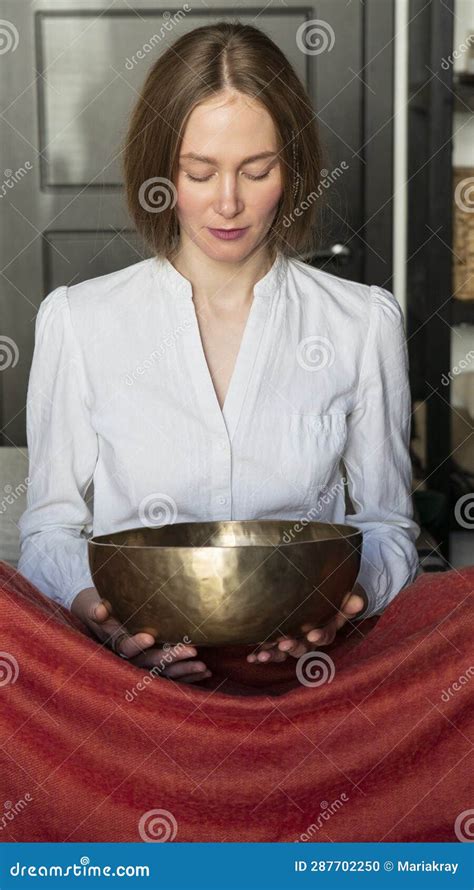 Woman Holding Tibetan Singing Bowl In Sound Therapy In Spa Center Stock