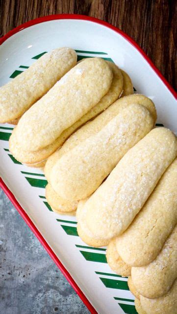 Some Cookies Are Sitting On A White And Red Plate With Green Stripes