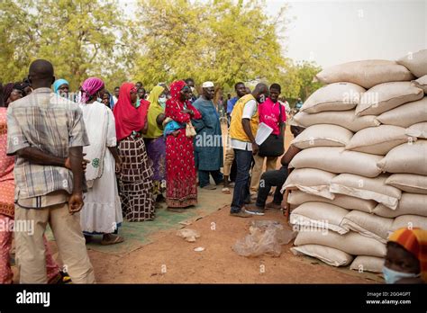 Sacks And Bags Of Food And Grain Are Distributed To Women And Men Affected By Conflict In