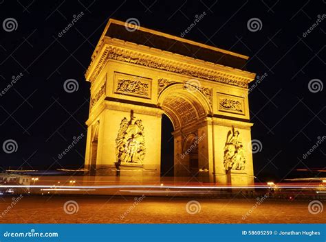 Traffic Goes Around The Arc De Triomphe At Night Stock Image