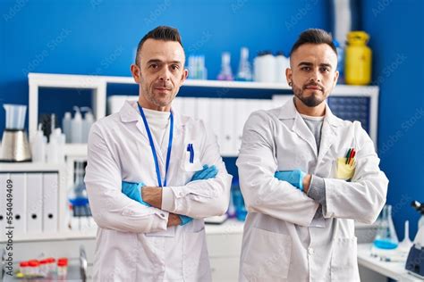 Two Men Scientists Standing With Relaxed Expression And Arms Crossed