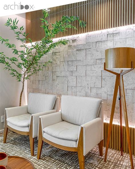 Two White Chairs Sitting Next To Each Other In Front Of A Wall Mounted